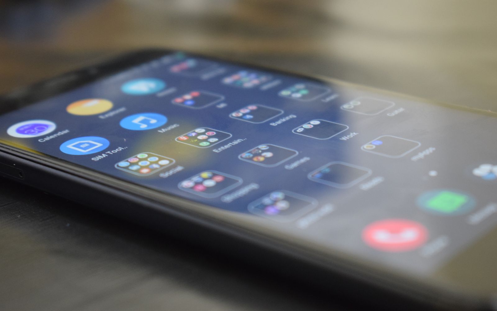 Close-up shot of a smartphone screen showing various app icons, indicating digital technology use.