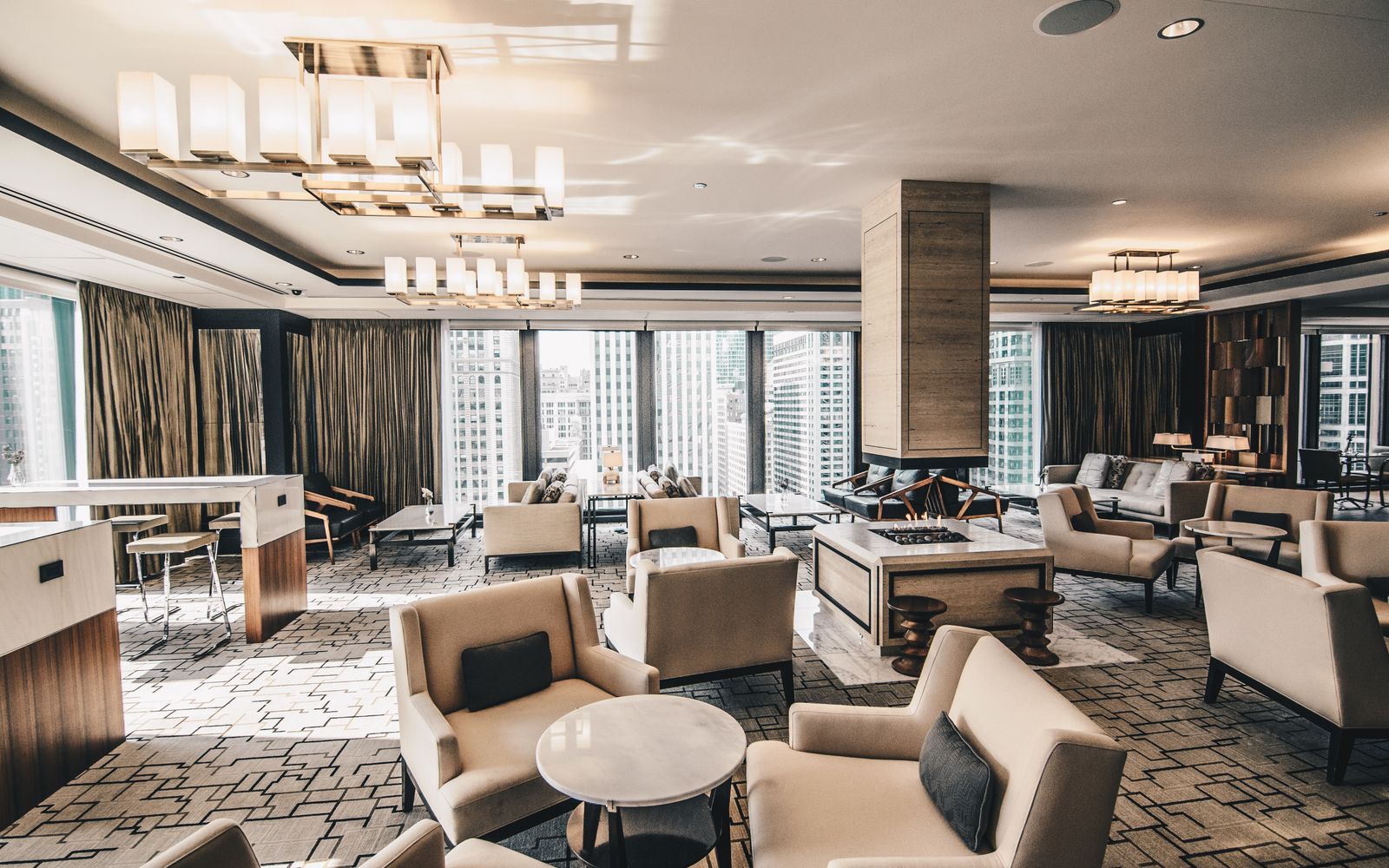 A contemporary hotel lounge in Chicago featuring elegant furniture and large windows.
